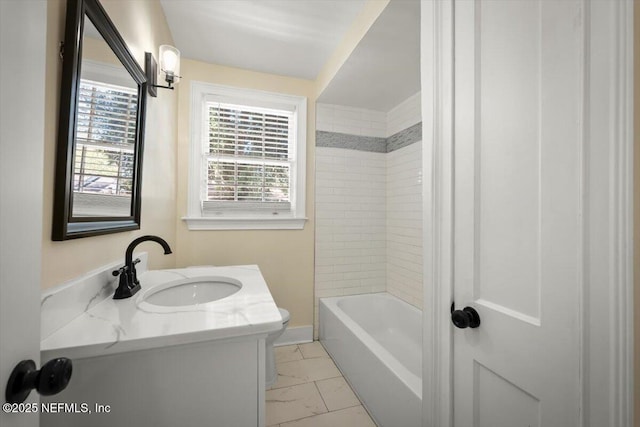 bathroom with vanity and tiled shower / bath