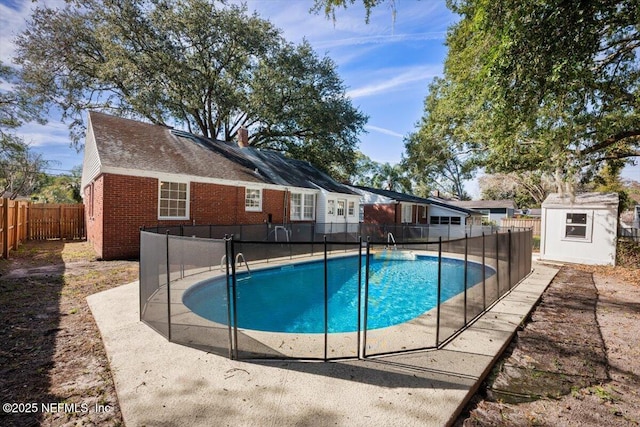 view of swimming pool featuring a storage shed