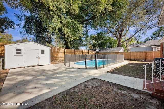 view of pool with a patio area and a shed