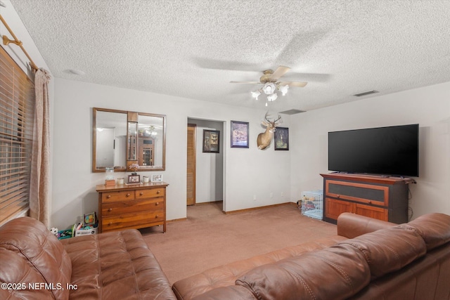 living room with light carpet, a textured ceiling, and ceiling fan