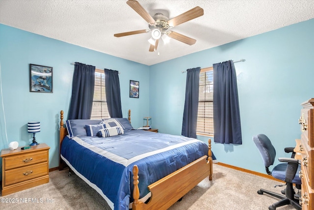 carpeted bedroom with ceiling fan and a textured ceiling