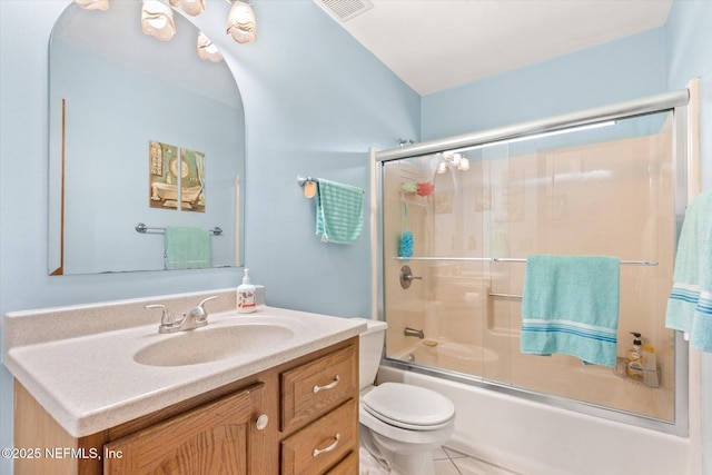 full bathroom featuring enclosed tub / shower combo, vanity, and toilet