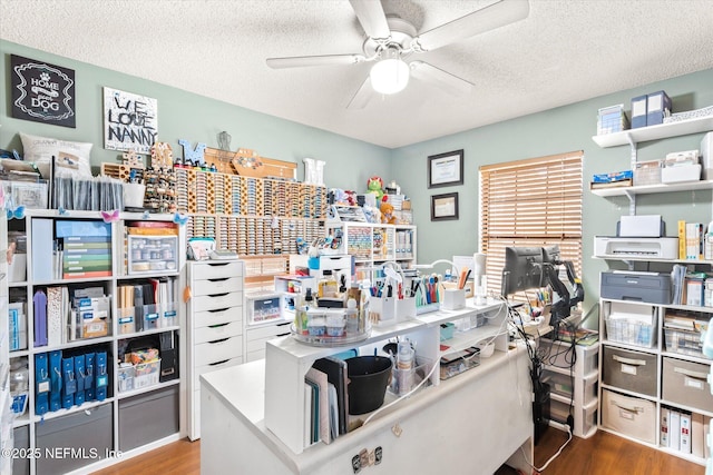 office space featuring hardwood / wood-style floors, a textured ceiling, and ceiling fan