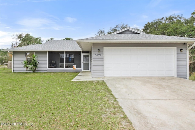 ranch-style house featuring a garage and a front lawn