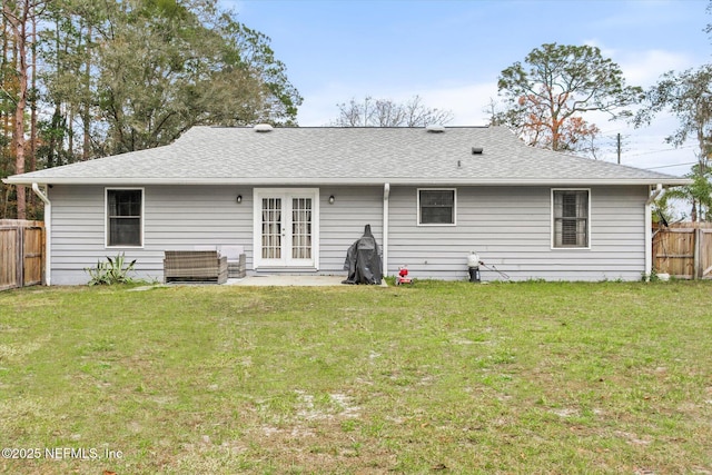 back of house with a lawn and french doors