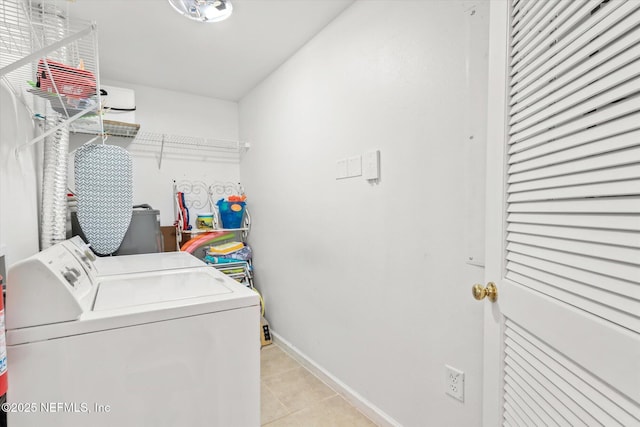 clothes washing area featuring independent washer and dryer and light tile patterned floors