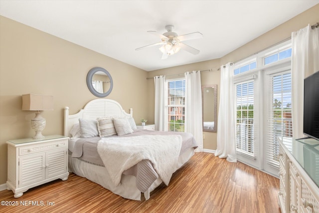 bedroom with ceiling fan, access to outside, and light wood-type flooring