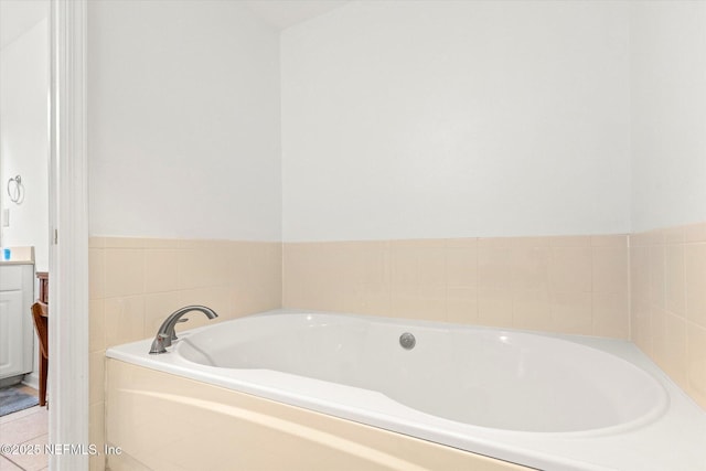 bathroom with tile patterned flooring and a tub to relax in