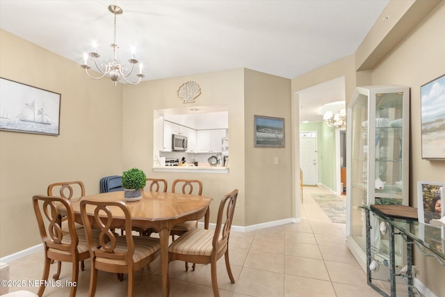 dining room with light tile patterned floors and an inviting chandelier