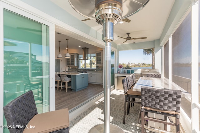 sunroom featuring ceiling fan