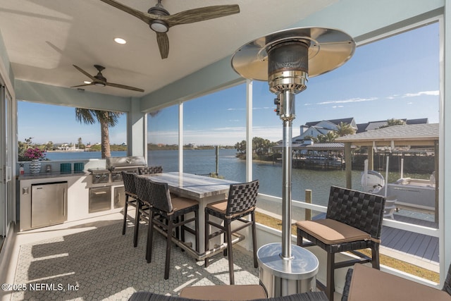 view of patio featuring area for grilling and a water view