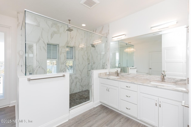 bathroom featuring vanity, hardwood / wood-style floors, and a shower with shower door