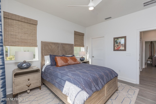 bedroom with light hardwood / wood-style floors and ceiling fan