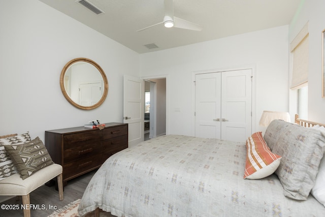 bedroom featuring dark hardwood / wood-style floors, a closet, and ceiling fan