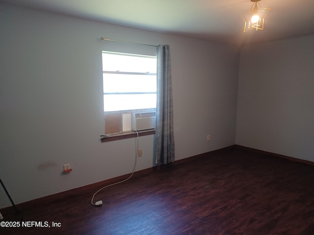 unfurnished room with cooling unit and dark hardwood / wood-style flooring