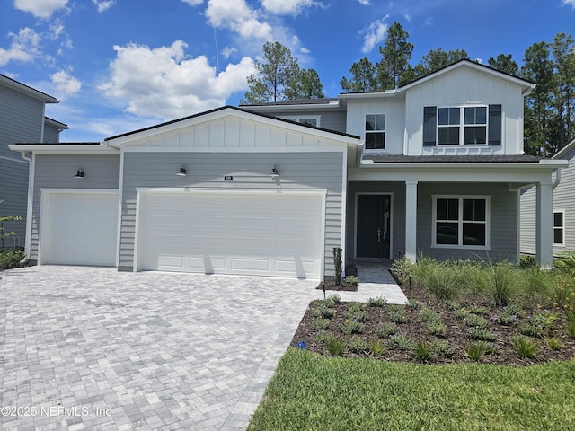 268 Dalton Mill Dr, Saint Johns, FL 32259 - view of front of house featuring board and batten siding, a garage, driveway, and covered porch