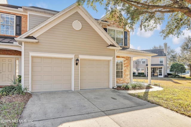 view of front of home featuring a garage and a front lawn