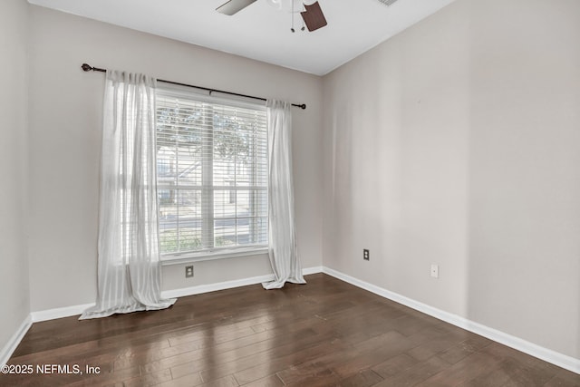 empty room with dark wood-type flooring and ceiling fan