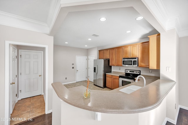 kitchen featuring ornamental molding, appliances with stainless steel finishes, kitchen peninsula, and sink