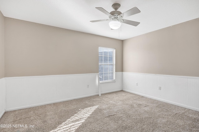 unfurnished room with light colored carpet and ceiling fan