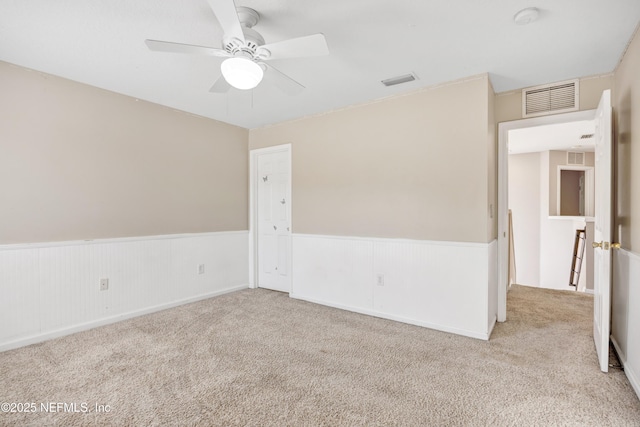 carpeted empty room featuring ceiling fan