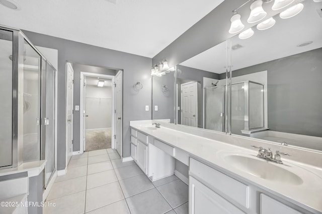 bathroom with tile patterned floors, separate shower and tub, and vanity