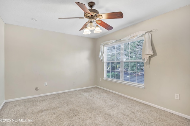 carpeted spare room with ceiling fan