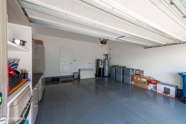 garage with a garage door opener and electric water heater