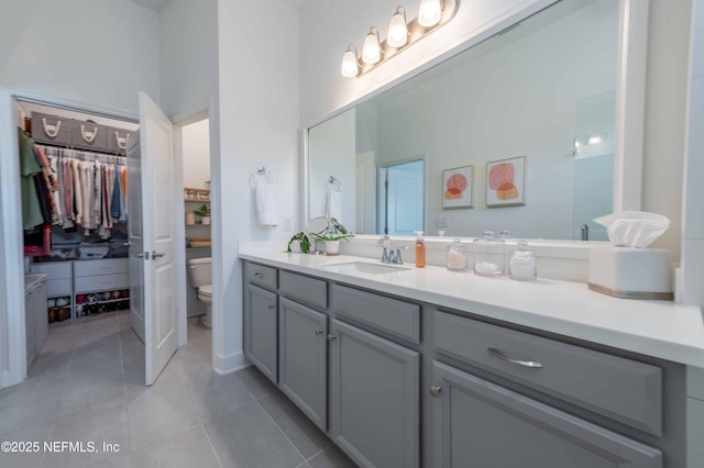 bathroom featuring vanity, toilet, and tile patterned flooring