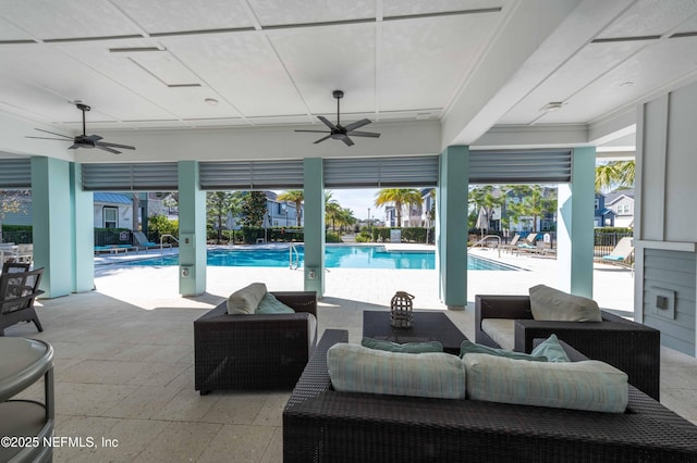 view of swimming pool featuring ceiling fan