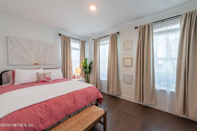 bedroom with dark hardwood / wood-style flooring