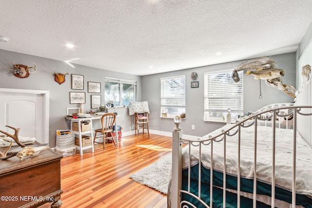 bedroom with hardwood / wood-style flooring and a textured ceiling