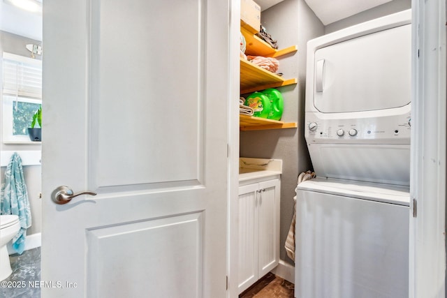 laundry room featuring stacked washer and clothes dryer