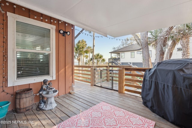 wooden deck with a grill