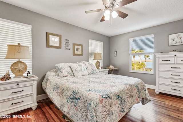 bedroom featuring dark hardwood / wood-style flooring and ceiling fan