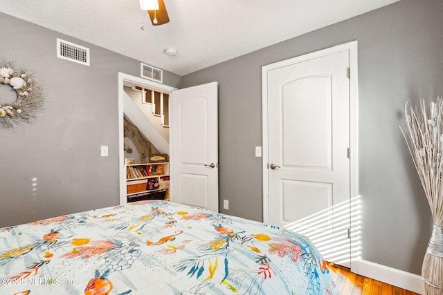 bedroom with hardwood / wood-style floors and ceiling fan