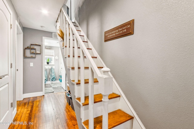 staircase featuring hardwood / wood-style flooring