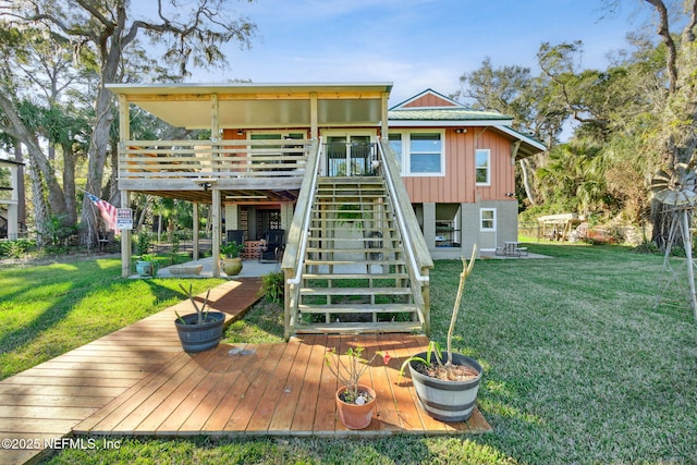 rear view of house featuring a yard, a deck, and a patio