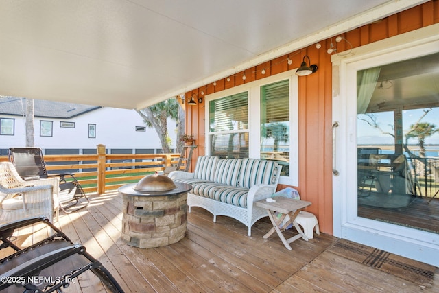 wooden terrace with an outdoor fire pit