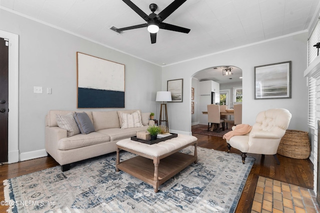 living room with hardwood / wood-style flooring, crown molding, and ceiling fan