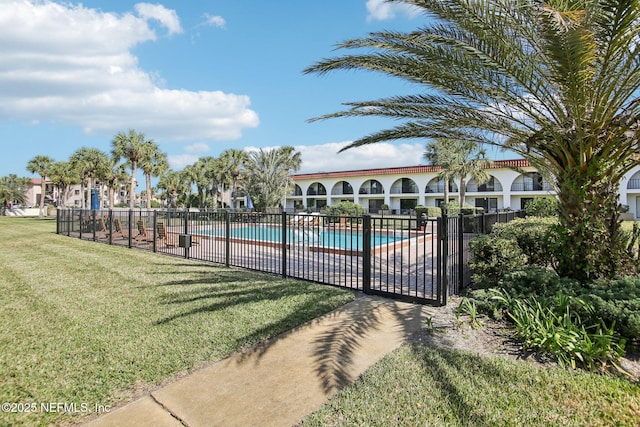 view of swimming pool with a lawn