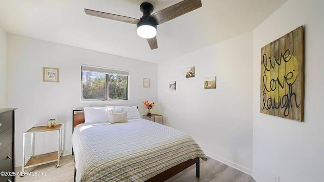 bedroom with ceiling fan and light wood-type flooring