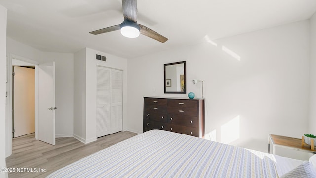 bedroom featuring ceiling fan, light wood-type flooring, and a closet