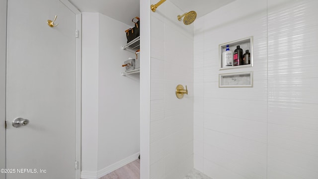 bathroom with a tile shower