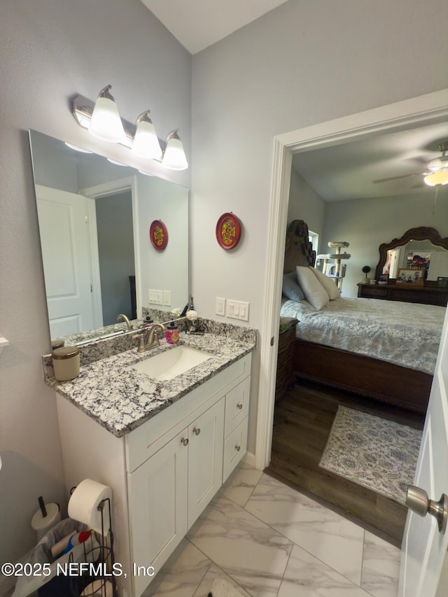 bathroom with a ceiling fan, marble finish floor, connected bathroom, and vanity