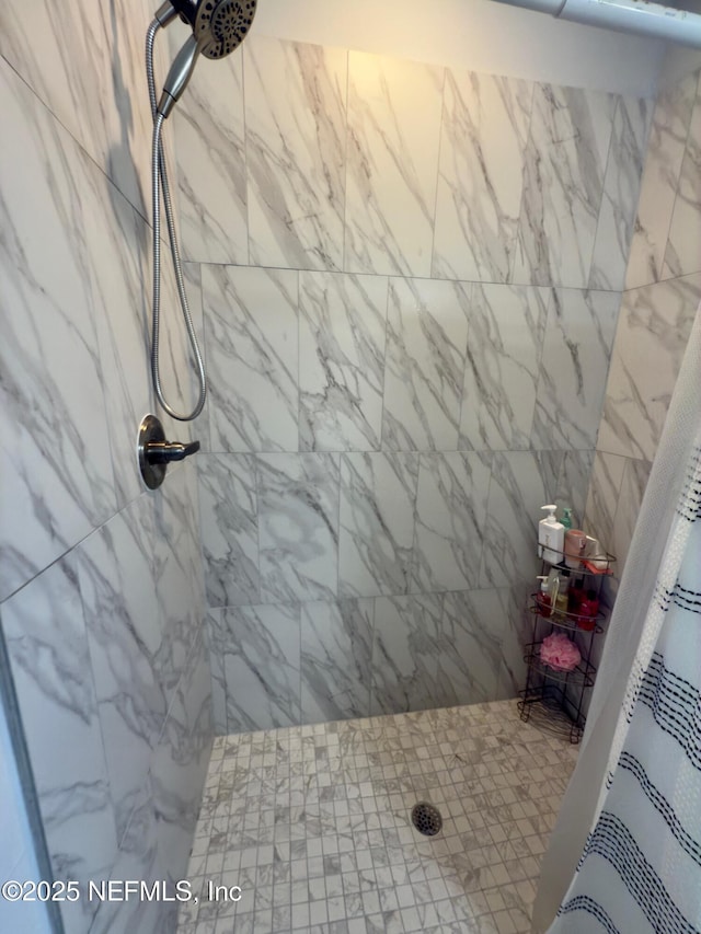 full bath featuring a tile shower