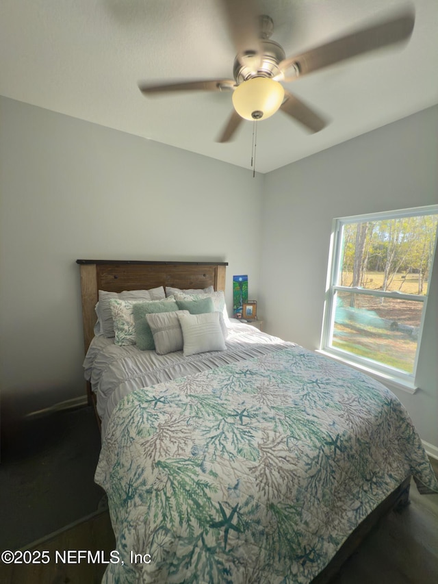 bedroom featuring baseboards and a ceiling fan