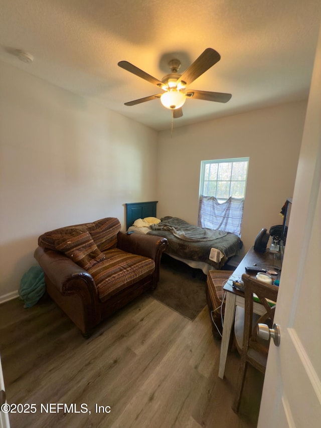 bedroom featuring a ceiling fan and wood finished floors