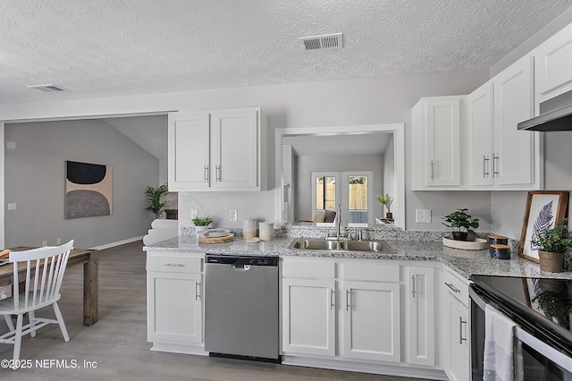 kitchen featuring light stone counters, sink, white cabinets, and dishwasher