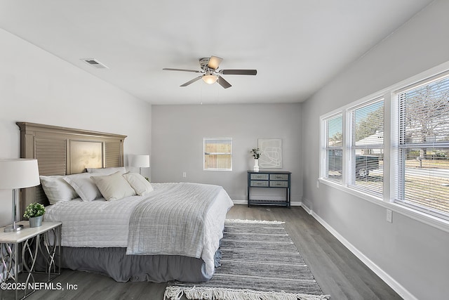 bedroom with dark hardwood / wood-style floors and ceiling fan